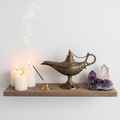 Antique brass Aladdin lamp on wooden meditation shelf with candles lifestyle home decor