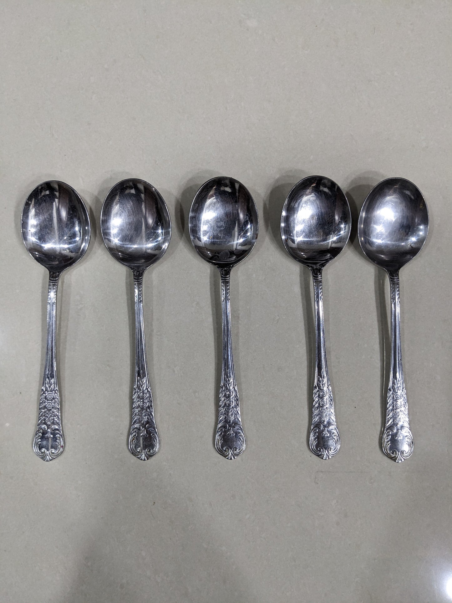 Angled top-down shot of the 5-piece vintage silver-plated collectible spoon set