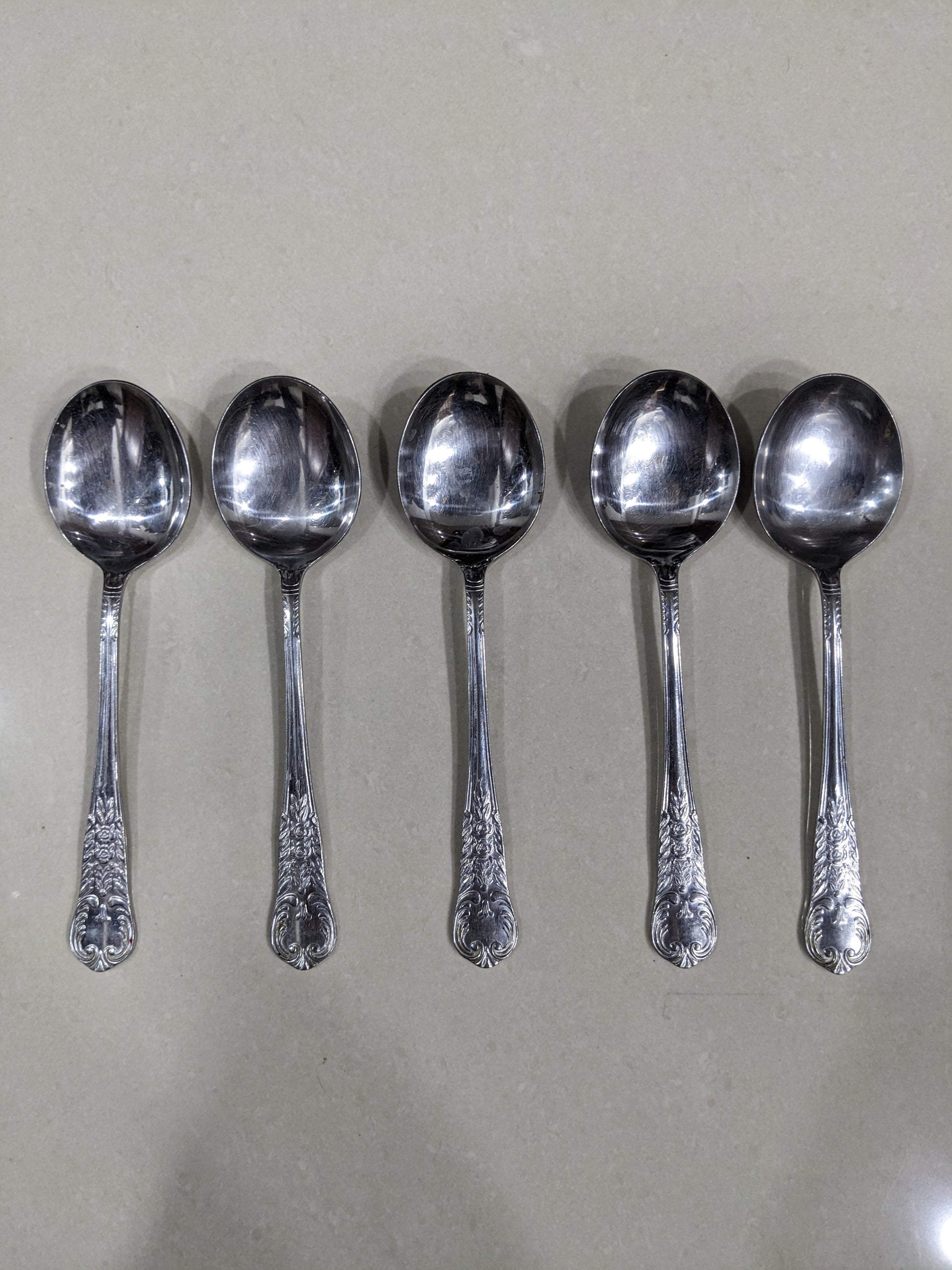 Angled top-down shot of the 5-piece vintage silver-plated collectible spoon set
